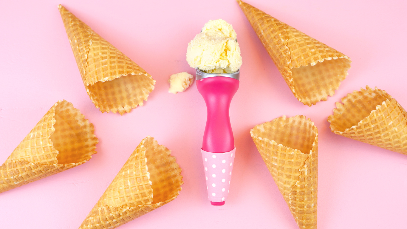 a pink background with ice cream cones and a pink ice cream scoop with a scoop of vanilla ice cream. pun because PokerStars 2022 Spring Championship of Online Poker AKA SCOOP is returning to PokerStars PA, NJ, & MI on March 25.